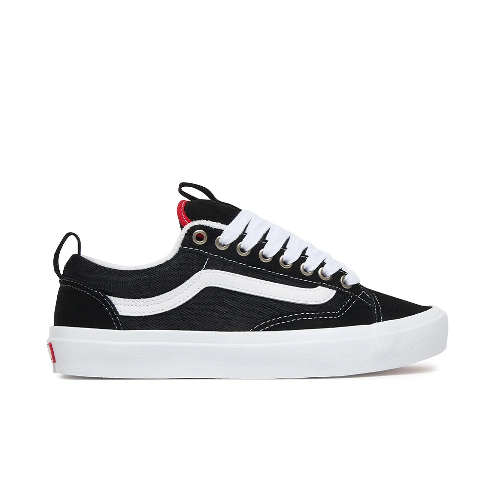 A black canvas low-top sneaker with white laces, silver eyelets, and a thick cream-colored platform sole, shown in a side profile on a white background.