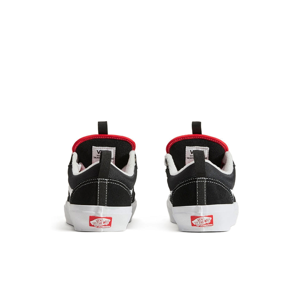 A pair of black Vans platform sneakers shown from the back, featuring a thick white platform sole, white stitching, a red inner collar lining, and the classic red Vans logo on the heel.